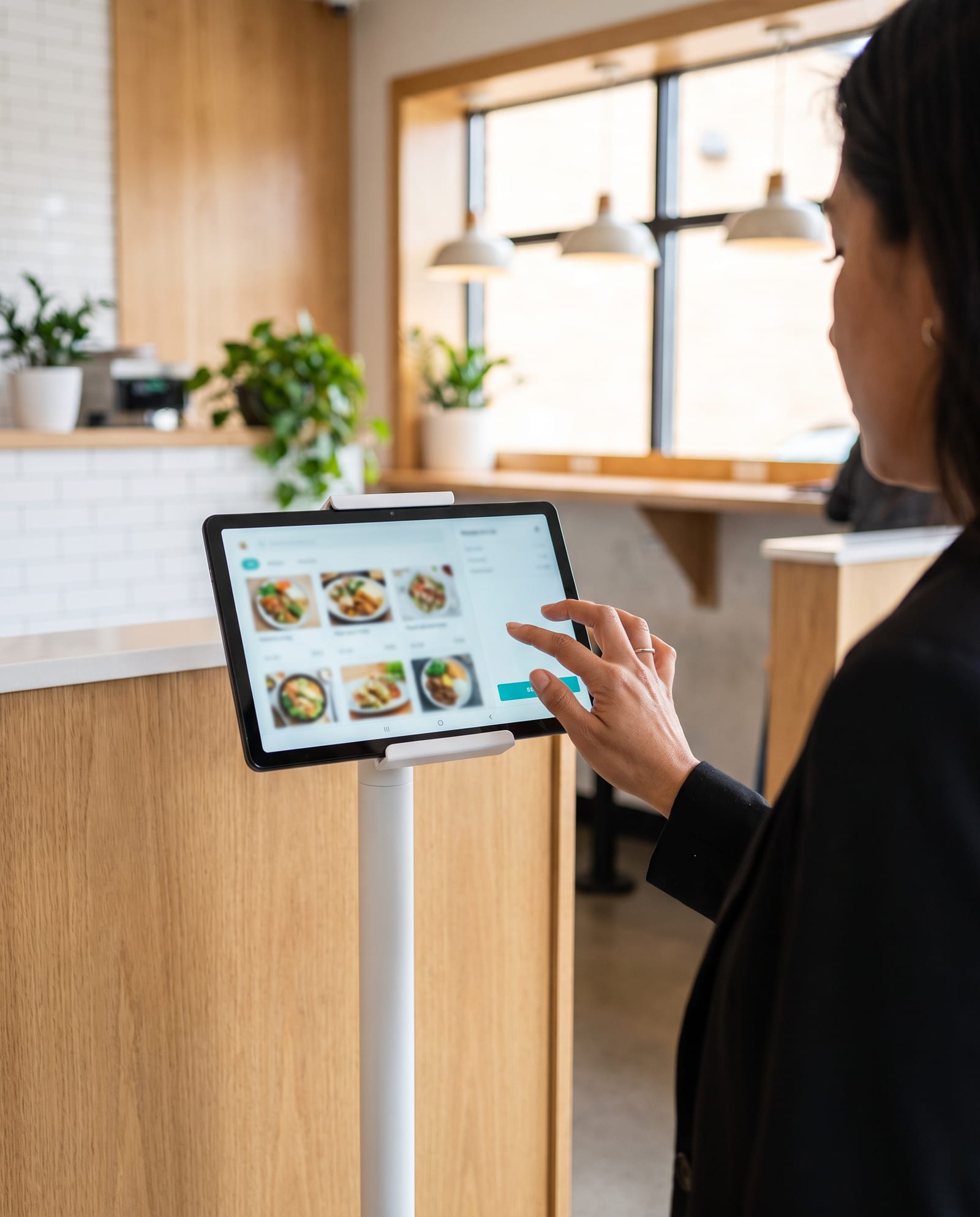 Customer using a self-service Android tablet on a stand